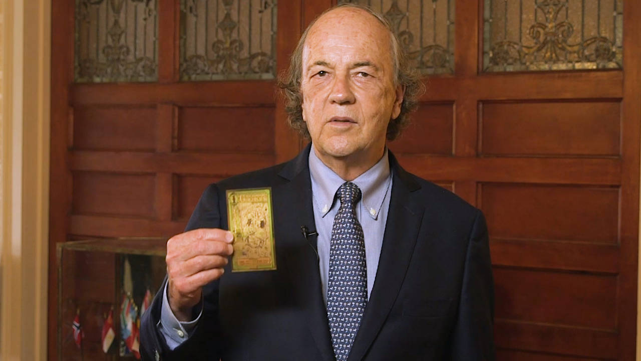 Jim Rickards holding a goldback