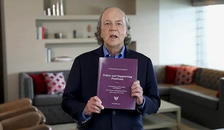Jim Rickards holding book